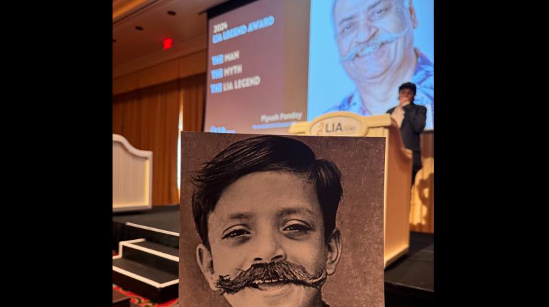 LIA creating the iconic moustache on Piyush's picture from his younger days.